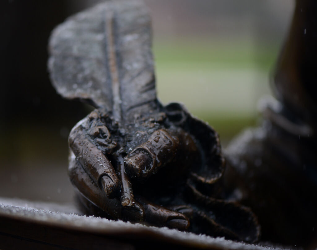 A snowflake melts on the tip of the Thomas Jefferson statue's quill